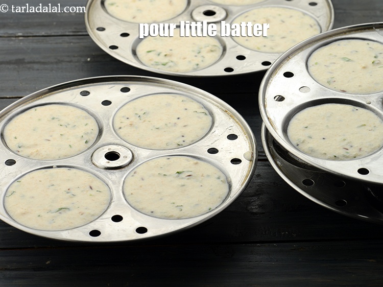 Step 35 – Pour spoonfuls of batter into each of the greased idli moulds. Do not over fill …