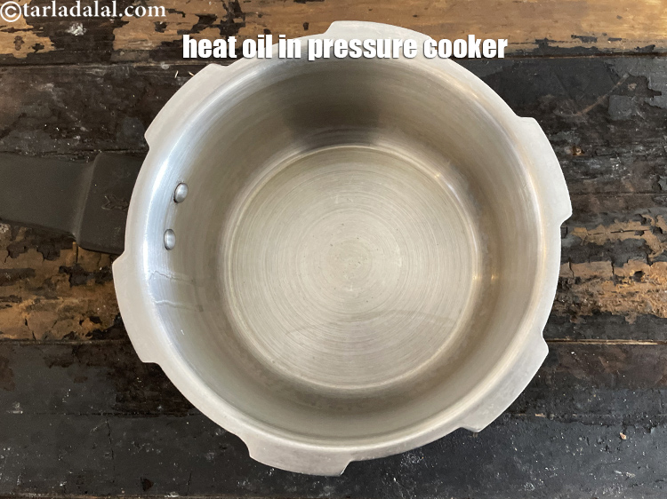 Step 10 – Heat <meta charset="UTF-8" />2 tsp&nbsp;<a href="glossary-oil-671i">oil</a>&nbsp;in a pressure cooker.