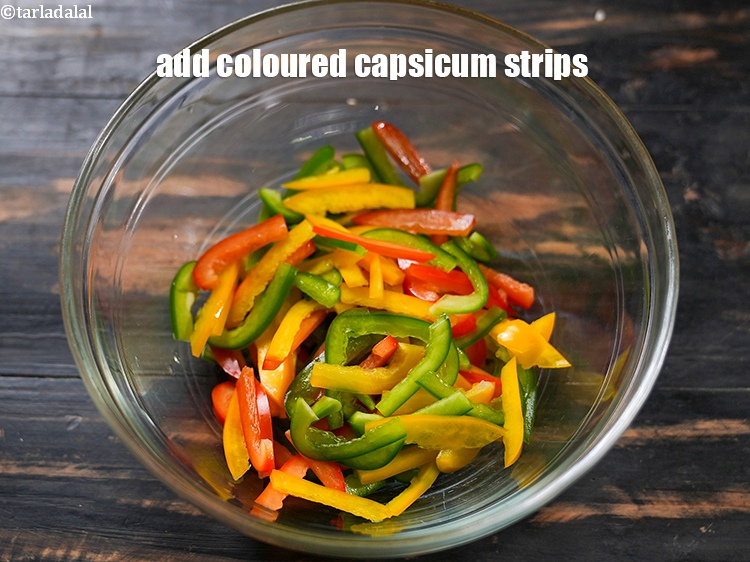 Step 3 – In a deep bowl, add 1/2 cup <a href="https://www.tarladalal.com/glossary-coloured-capsicum-strips-2802i">coloured capsicum strips</a>.