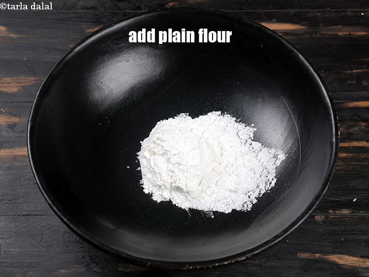 Step 3 – In a deep bowl, add &frac14; cup plain flour.