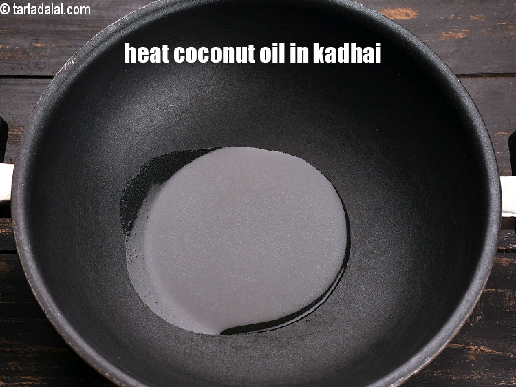 Step 3 – To make <strong>beans poriyal</strong>, heat 1 tbsp coconut oil in a kadhai.