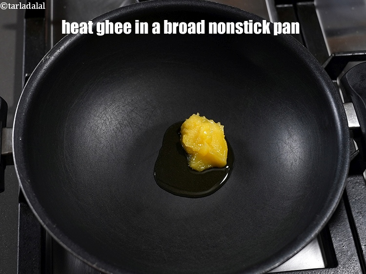 Step 3 – To make <strong>orange barfi</strong>, heat <a href="https://www.tarladalal.com/glossary-ghee-245i">ghee</a> in a broad nonstick pan.