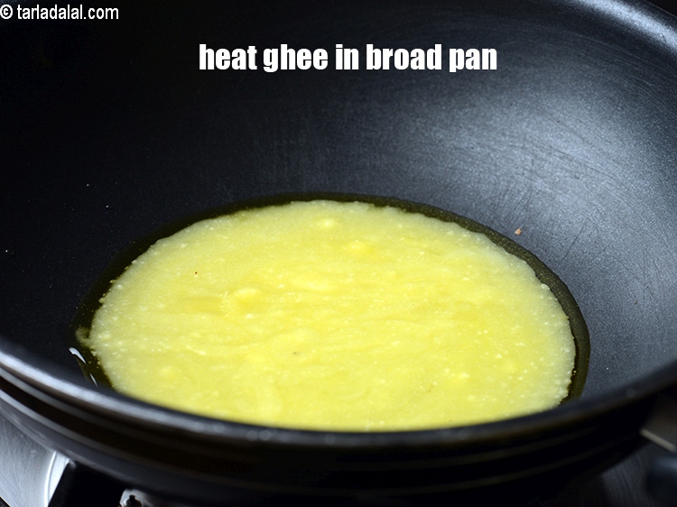 Step 3 – To make <strong>banana sheera</strong>, heat 1/3 cup ghee in a broad non-stick pan.