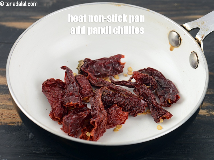Step 4 – Heat a small non-stick pan add 5 whole <a href="https://www.tarladalal.com/glossary-pandi-chillies-pandi-dry-red-chillies-2373i">pandi chillies</a>, broken into pieces.