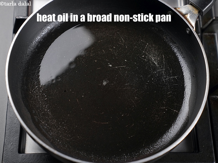 Step 8 – To make <strong>vermicelli idli recipe</strong>, heat 4 tbsp of oil in a broad non-stick pan.