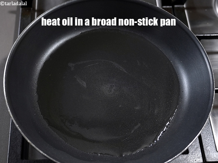 Step 7 – To make <strong>corn palak pulao</strong>, heat 2 tbsp oil in a broad non-stick pan.