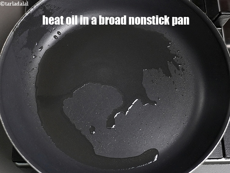 Step 3 – To make <strong>matar paneer recipe</strong>, heat 1 tbsp <a href="https://www.tarladalal.com/glossary-oil-671i">oil</a> in a broad nonstick pan.