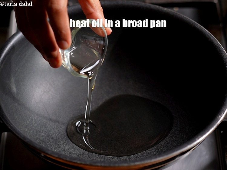 Step 3 – To make<strong> instant poha premix</strong>, heat 2 tbsp oil in a broad nonstick pan.