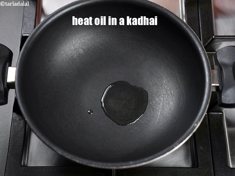 Step 3 – To make <strong>cluster beans poriyal</strong>, heat 1 tsp oil in a non-stick kadhai.