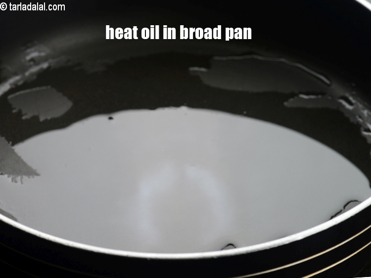 Step 3 – Heat 2 tsp oil in a broad non-stick pan.