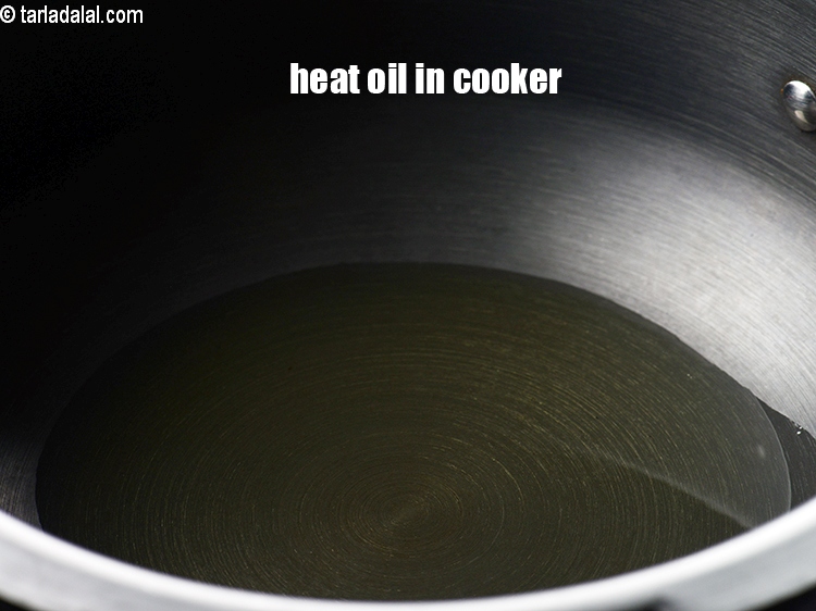 Step 3 – To make <strong>pressure cooker biryani</strong>, heat 2 tbsp oil in a pressure cooker.