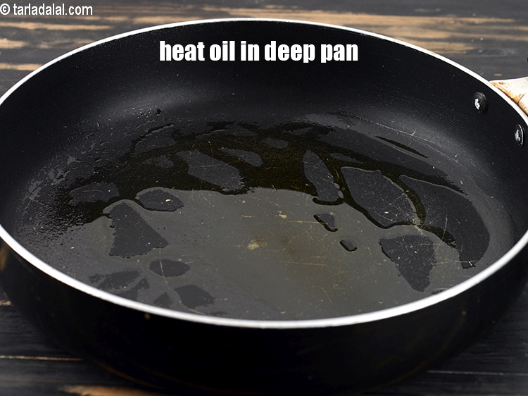 Step 3 – To make <strong>chanar dalna recipe</strong>, heat 1 tsp oil in a deep non-stick pan.