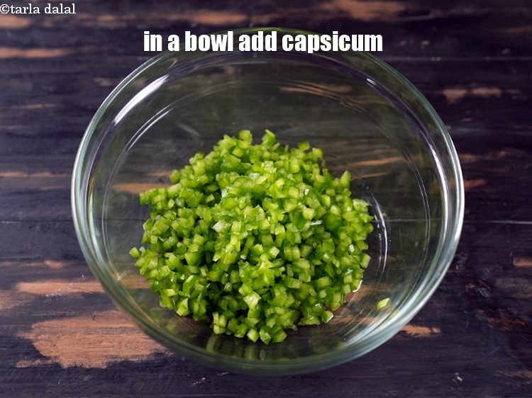 Step 3 – In a bowl, add 1 cup finely <a href="https://www.tarladalal.com/glossary-chopped-capsicum-164i">chopped capsicum</a>.