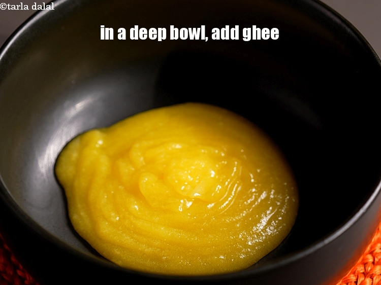Step 3 – To make <strong>eggless ghee cake</strong>, in a deep bowl, add &frac12; cup ghee.