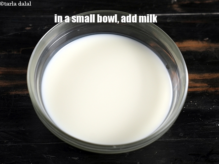 Step 3 – To make <strong>fruit custard</strong>, in a small bowl, add 1/2 cup <a href="https://www.tarladalal.com/glossary-milk-doodh-full-cream-milk-514i">milk</a>.