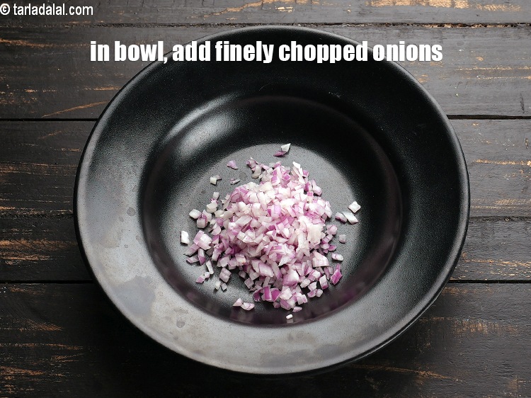 Step 3 – To make <strong>thepla sandwich</strong>, in a deep bowl, add &frac14; cup finely chopped onions.