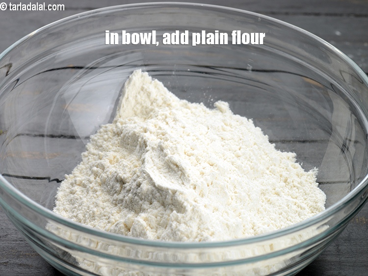 Step 3 – To make <strong>eggless chocolate waffle</strong>, in a deep bowl, 1&frac12; cups plain flour.