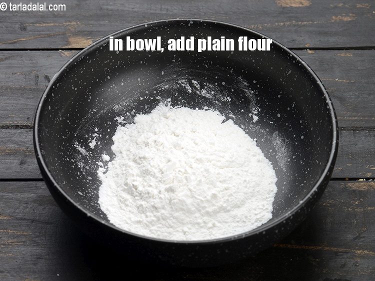 Step 4 – In a small bowl, add &frac14; cup <a href="https://www.tarladalal.com/glossary-plain-flour-maida-188i">plain flour (maida)</a>.