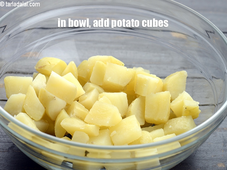 Step 3 – In a deep bowl, add 2 cups&nbsp;<a href="https://tarladalal.com/glossary-boiled-sweet-potato-cubes-2316i">boiled and peeled potato cubes</a>.&nbsp;