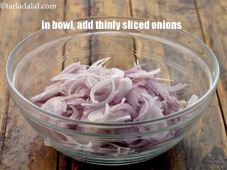 Step 3 – In a deep bowl, add 1&frac12; cups thinly <a href="https://www.tarladalal.com/glossary-sliced-onions-745i">sliced onions</a>.