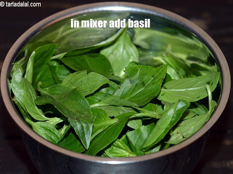Step 3 – To make <strong>basil walnut dressing</strong>, in a mixer add 1 cup <a href="https://www.tarladalal.com/glossary-basil-185i">basil</a>.