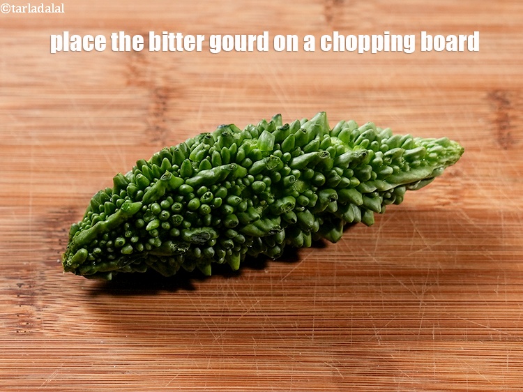 Step 3 – Wash and&nbsp;place the bitter gourd on a chopping board.<br /> &nbsp;
