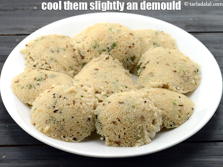 Step 39 – Once the idlis are cooked, cool them slightly. Dip a spoon in the water and …