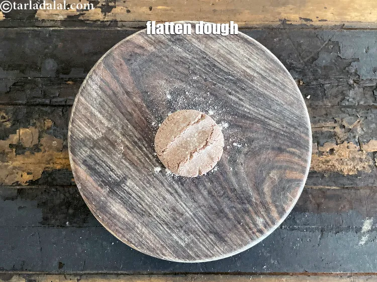 Step 22 – Take one&nbsp;portion of the dough and flatten it.