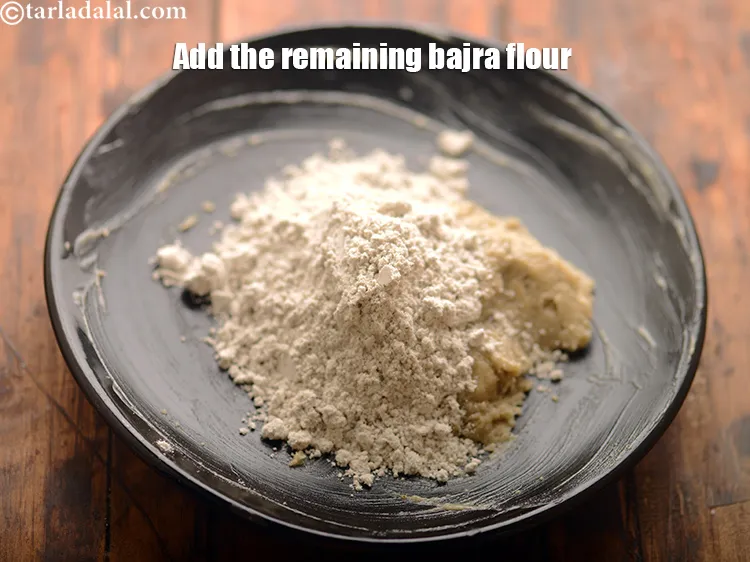 Step 23 – Add the remaining <a href="https://www.tarladalal.com/glossary-bajra-flour-bajra-ka-atta-bajre-ka-atta-176i">bajra (black millet) flour</a>.&nbsp;