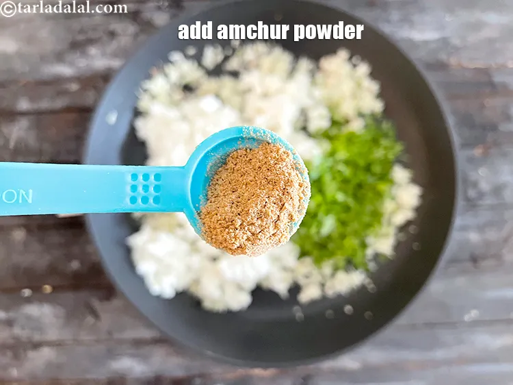 Step 34 – Add&nbsp;1/2 tsp&nbsp;<a href="https://www.tarladalal.com/glossary-dried-mango-powder-amchur-powder-148i" target="_blank">dried mango powder (amchur)</a>.