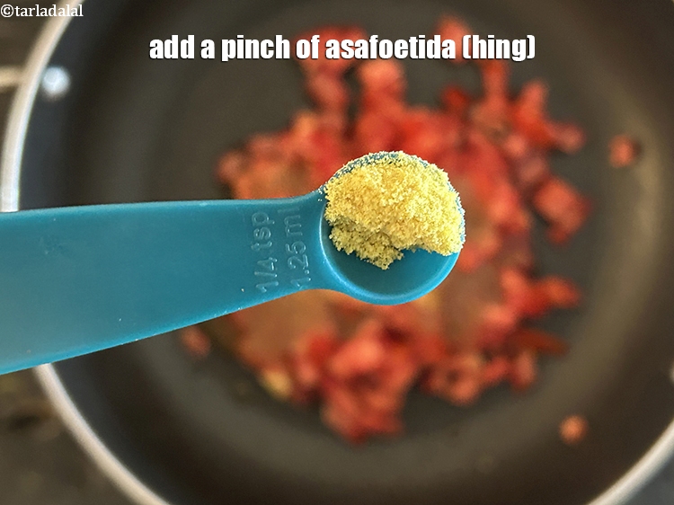Step 14 – Add&nbsp;<meta charset="UTF-8" />a pinch of&nbsp;<a href="glossary-asafoetida-hing-113i">asafoetida (hing)</a>.