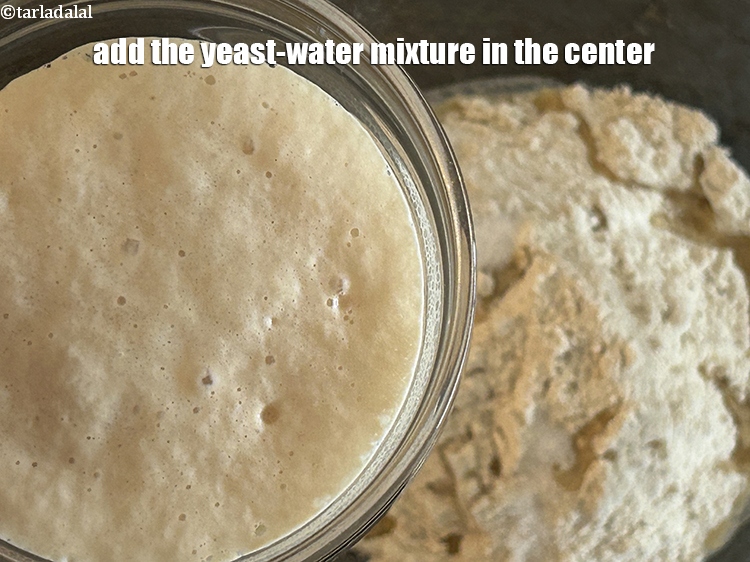 Step 13 – <meta charset="UTF-8" />Add the yeast-water mixture in the center.&nbsp;<br /> &nbsp;