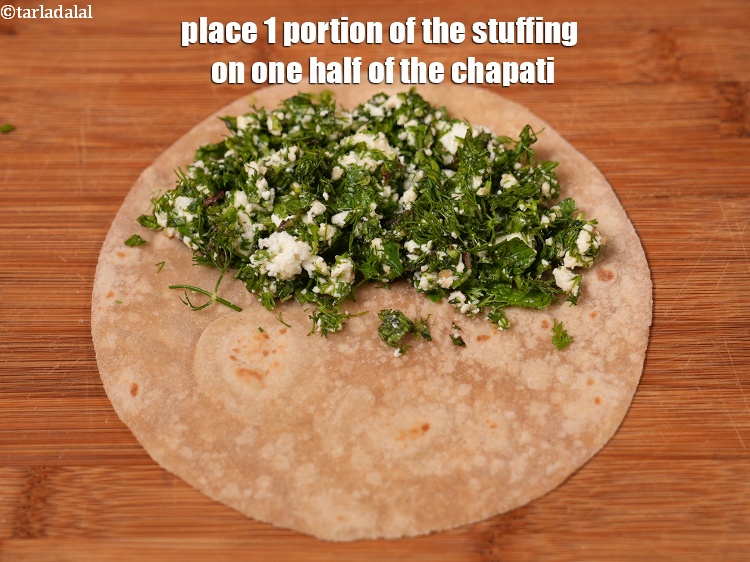 Step 12 – Place 1 portion of the stuffing on one half of the chapati.