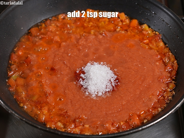 स्टेप 11 – शक्कर डालें। शक्कर टमाटर के खटेपन को संतुलित करने में …