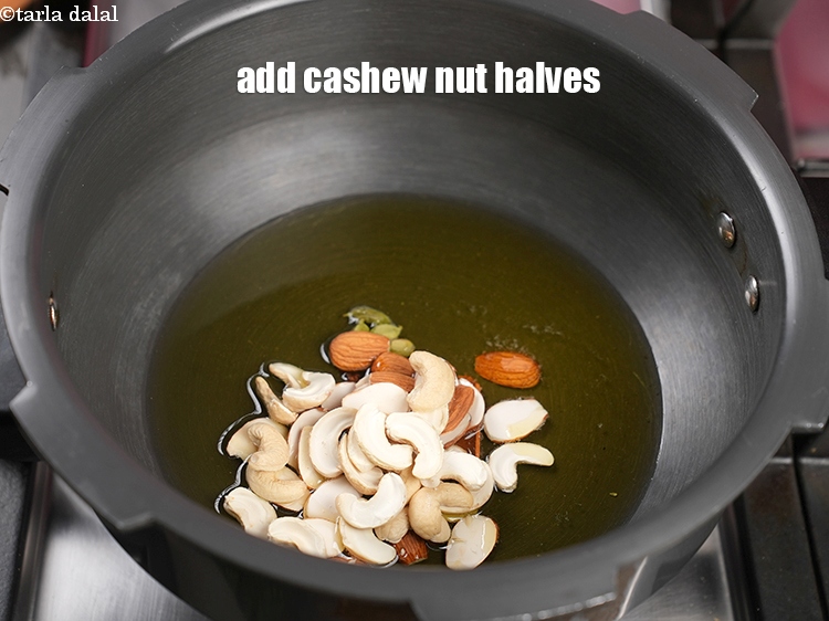 Step 12 – Add 2 tbsp <a href="https://www.tarladalal.com/glossary-cashew-nut-halves-2511i">cashew nut (kaju) halves</a>.
