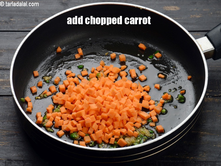 Step 13 – Add &frac12; cup chopped <a href="https://www.tarladalal.com/glossary-carrot-gajar-gajjar-253i">carrot</a>.