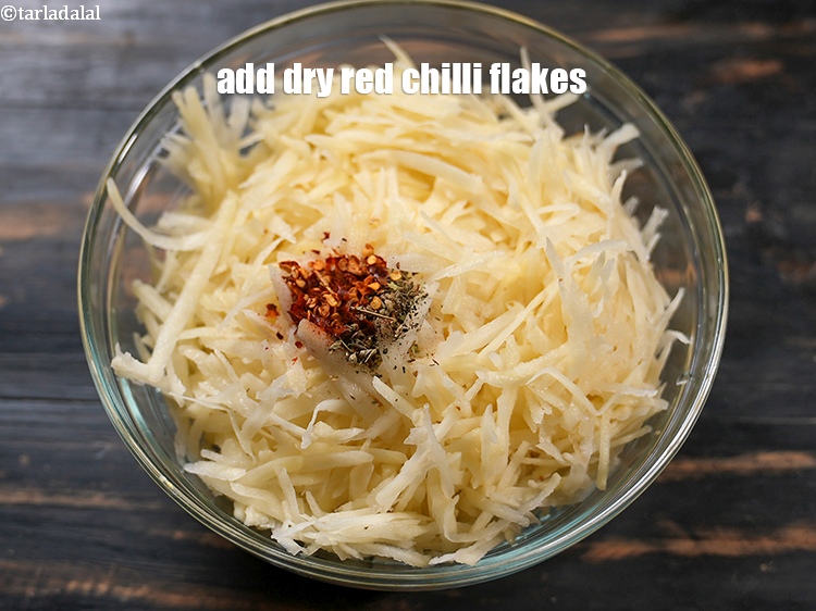 Step 12 – Add 1/2 tsp <a href="https://www.tarladalal.com/glossary-dry-red-chilli-flakes-paprika-338i">dry red chilli flakes (paprika)</a>.