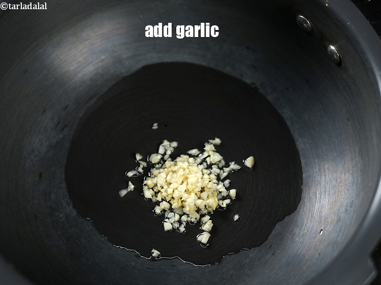 Step 12 – Add 1 tbsp finely&nbsp;<a href="https://www.tarladalal.com/glossary-chopped-garlic-790i">chopped garlic (lehsun)</a>.