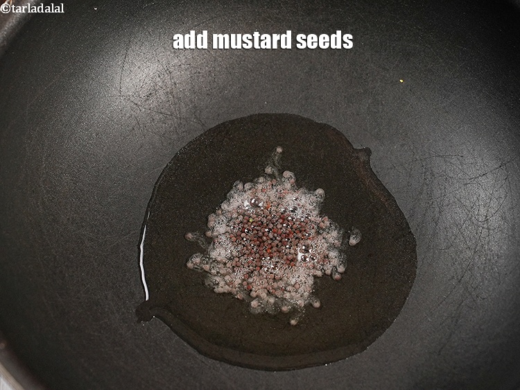 Step 12 – Add &frac12; tsp <a href="https://www.tarladalal.com/glossary-mustard-seeds-sarson-rai-sarson-ke-beej-525i">mustard seeds ( rai / sarson)</a>.&nbsp;