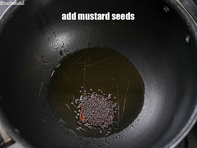 Step 12 – Add 2 tsp <a href="https://www.tarladalal.com/glossary-mustard-seeds-sarson-rai-sarson-ke-beej-525i">mustard seeds ( rai / sarson)</a>.&nbsp;