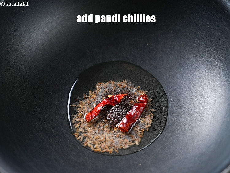 स्टेप 12 – २&nbsp;<a href=""https://www.tarladalal.com/glossary-pandi-chillies-pandi-dry-red-chillies-hindi-2373i"" target=""_blank"">सूखी साबुत पंडी मिर्च</a>&nbsp;डालें।