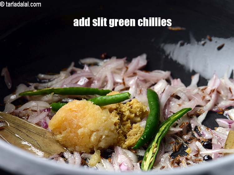 Step 12 – Add 2 slit <a href="https://www.tarladalal.com/glossary-green-chillies-hari-mirch-331i">green chillies</a>.