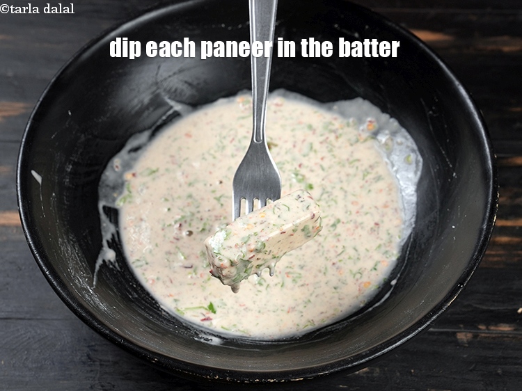 Step 12 – To make <strong>sesame paneer recipe</strong>, dip each sliced paneer in the prepared batter.