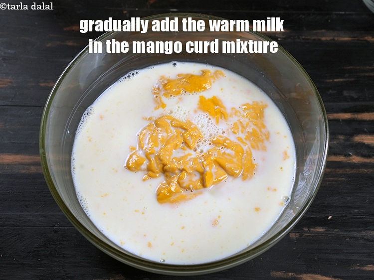 Step 13 – Gradually add the warm milk in the mango curd mixture.