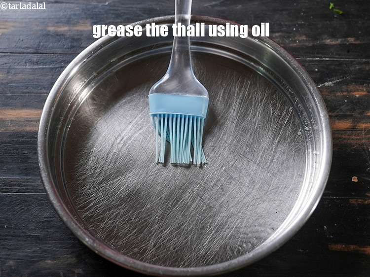 Step 12 – Grease a 175 mm. (7&rdquo;) diameter thali using &frac12; tsp of oil.