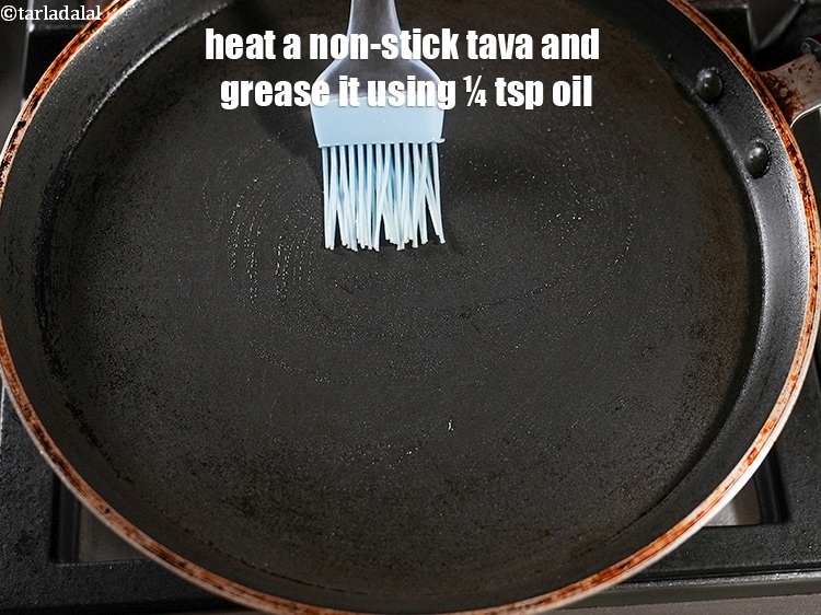 Step 12 – Heat a non-stick tava (griddle), grease it using &frac14; tsp oil.
