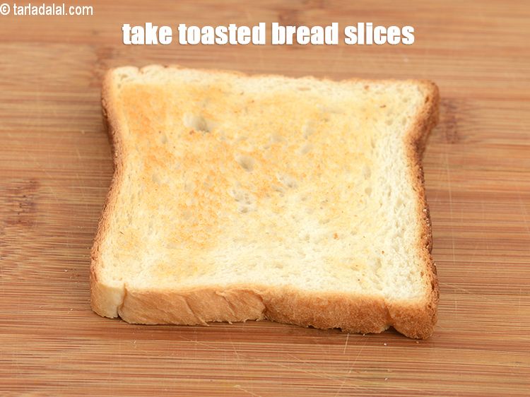 Step 12 – Take a&nbsp;<a href="https://www.tarladalal.com/glossary-toasted-bread-slices-2334i">toasted bread slices</a> on a clean, dry surface.&nbsp;