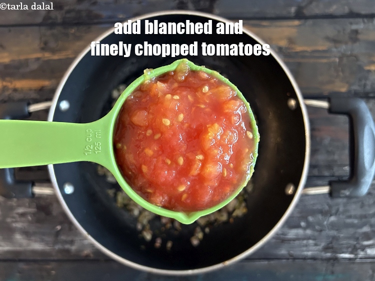 Step 16 – Add <strong>1/2 cup blanched and finely chopped tomatoes.</strong>