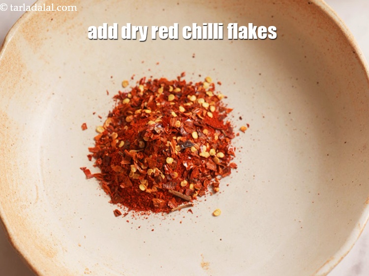 Step 21 – Now, add 2 tsp&nbsp;<a href="https://www.tarladalal.com/glossary-dry-red-chilli-flakes-paprika-338i">dry red chilli flakes (paprika)</a>.