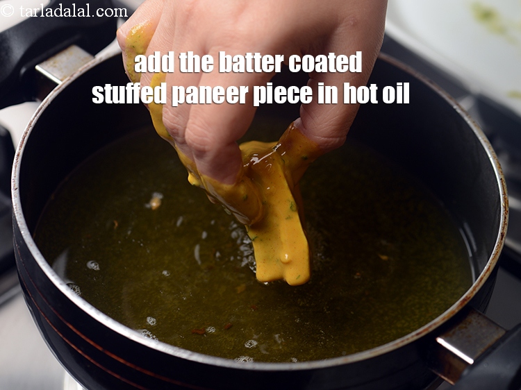Step 23 – Add the batter coated stuffed paneer piece in hot oil.